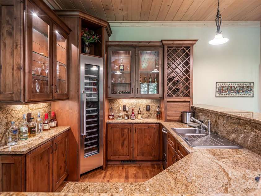 97 Lombard Street, Waynesville, NC 28786.  MLS# CAR4282341, YatesRealty ID 32568. Terrace level bar with custom cabinets, Thermador tower wine cooler, thermador beverage refrigerator, and dishwasher