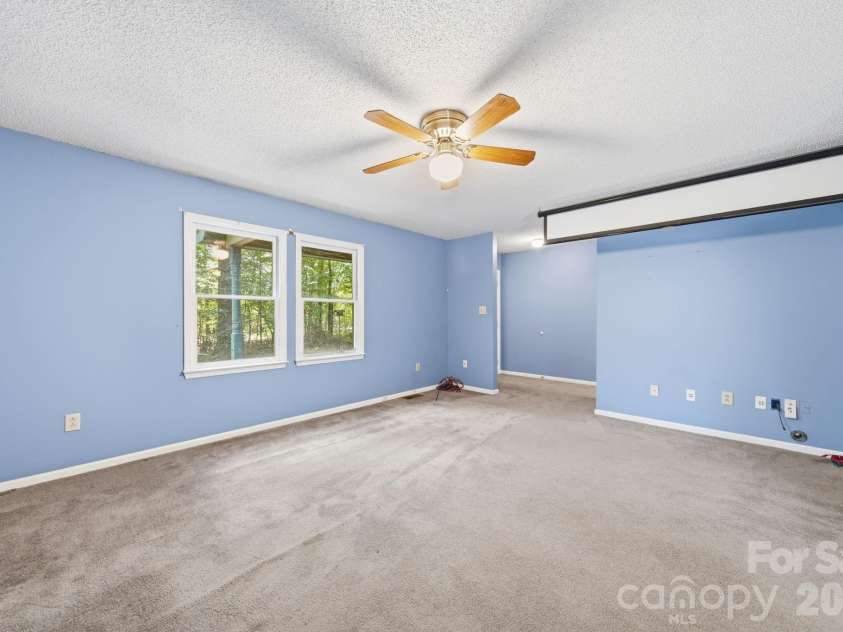 11488 Beagle Street, Midland, NC 28107.  MLS# CAR4397037, YatesRealty ID 32579. Living Room projector screen.