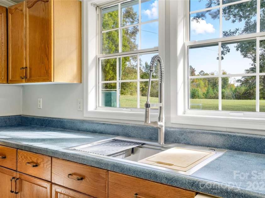 1116 Lewis Ferry Road, Statesville, NC 28677.  MLS# CAR4311790, YatesRealty ID 32594. Updated Kitchen faucet and window overlooking front yard