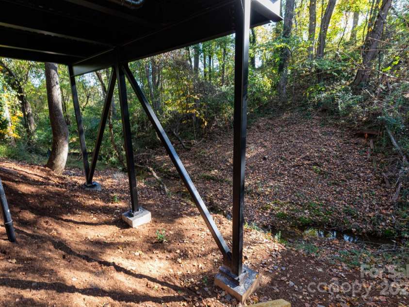 32 Waynesville Avenue, Asheville, NC 28806.  MLS# CAR4288925, YatesRealty ID 32595. Under the home, looking towards creek