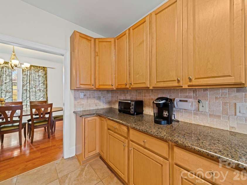 10962 Busbin Road, Mount Pleasant, NC 28124.  MLS# CAR4352597, YatesRealty ID 3260. Granite countertops and tile backsplash accent the kitchen area.