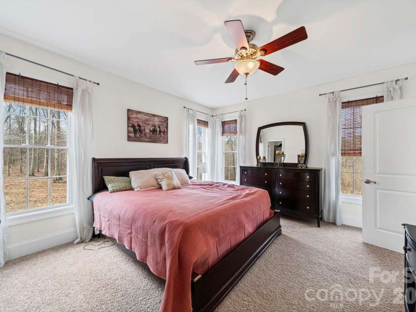 10962 Busbin Road, Mount Pleasant, NC 28124.  MLS# CAR4352597, YatesRealty ID 3260. Large primary bedroom with walk-in closet and bath.