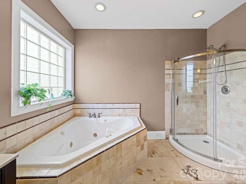 10962 Busbin Road, Mount Pleasant, NC 28124.  MLS# CAR4352597, YatesRealty ID 3260. Primary bath with jetted garden tub and shower.