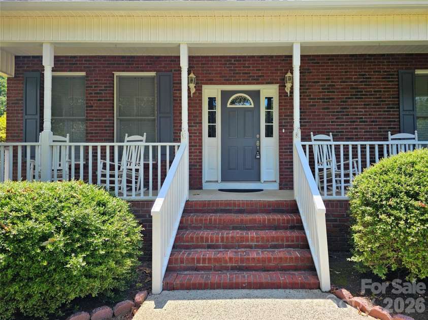 3486 Victorian Hills Drive, Richburg, SC 29729.  MLS# CAR4332522, YatesRealty ID 32618. Front Entrance, Brick Steps, Concrete Floor Front Porch, Rocking Chairs, Security