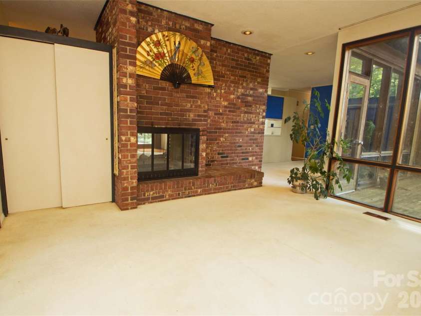 2638 Rolling Hills Drive, Monroe, NC 28110.  MLS# CAR4394198, YatesRealty ID 32619. Living room features a see-thru fireplace with gas logs.
