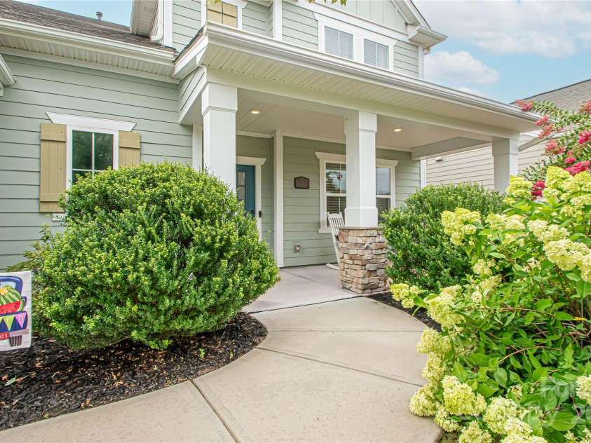 1061 Ansley Park Drive, Fort Mill, SC 29707.  MLS# CAR4281028, YatesRealty ID 32626. Beautiful flowering bushes and trees—including hydrangeas and crape myrtles—surround the front entrance, creating a colorful and inviting welcome.