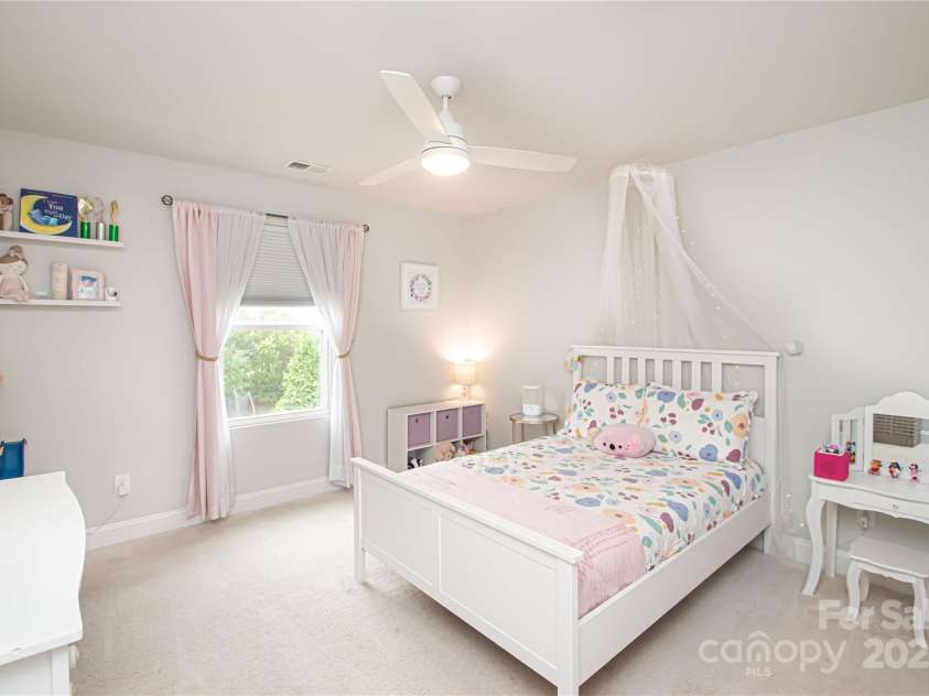 1061 Ansley Park Drive, Fort Mill, SC 29707.  MLS# CAR4281028, YatesRealty ID 32626. Bedroom 2 is generously sized and features a ceiling fan with light kit and a spacious walk-in closet.