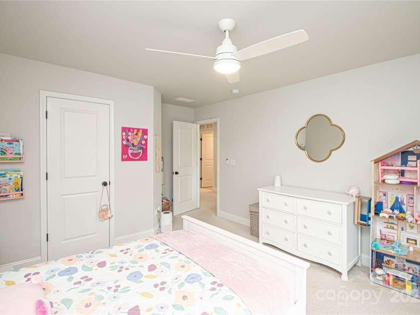 1061 Ansley Park Drive, Fort Mill, SC 29707.  MLS# CAR4281028, YatesRealty ID 32626. Bedroom 2 is generously sized and features a ceiling fan with light kit and a spacious walk-in closet.