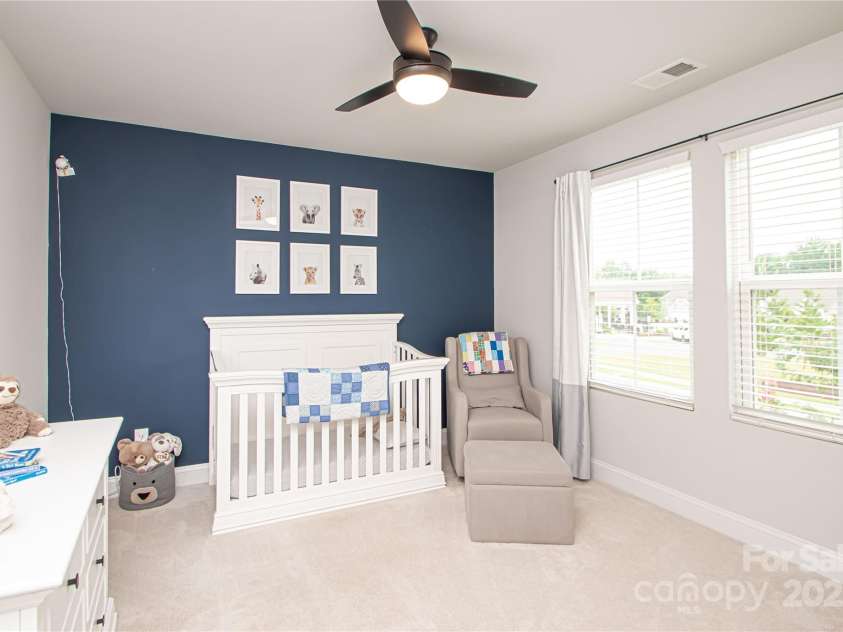 1061 Ansley Park Drive, Fort Mill, SC 29707.  MLS# CAR4281028, YatesRealty ID 32626. Bedroom 3 is also generously sized, offering a ceiling fan with light kit and a large walk-in closet for ample storage.