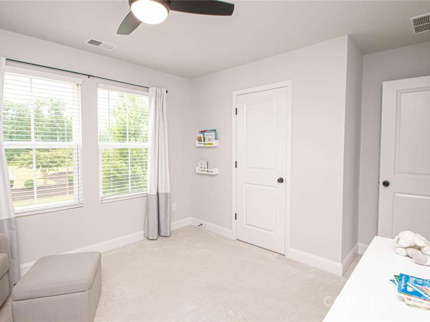 1061 Ansley Park Drive, Fort Mill, SC 29707.  MLS# CAR4281028, YatesRealty ID 32626. Bedroom 3 is also generously sized, offering a ceiling fan with light kit and a large walk-in closet for ample storage.