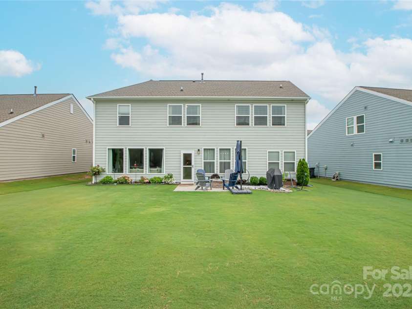 1061 Ansley Park Drive, Fort Mill, SC 29707.  MLS# CAR4281028, YatesRealty ID 32626. The expansive, level backyard offers endless possibilities—ideal for adding a pool, installing a fence, or creating your own private outdoor oasis.