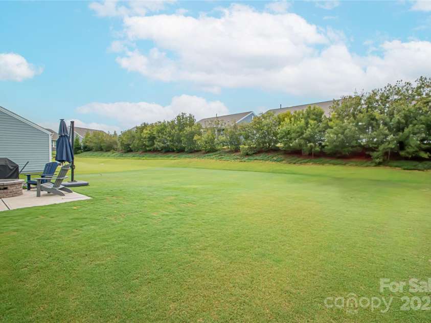 1061 Ansley Park Drive, Fort Mill, SC 29707.  MLS# CAR4281028, YatesRealty ID 32626. The expansive, level backyard offers endless possibilities—ideal for adding a pool, installing a fence, or creating your own private outdoor oasis.