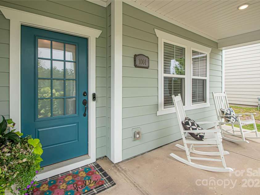 1061 Ansley Park Drive, Fort Mill, SC 29707.  MLS# CAR4281028, YatesRealty ID 32626. The exterior features durable Hardie Plank siding, and the charming front porch is ideal for rocking chairs—perfect for relaxing and enjoying the day.