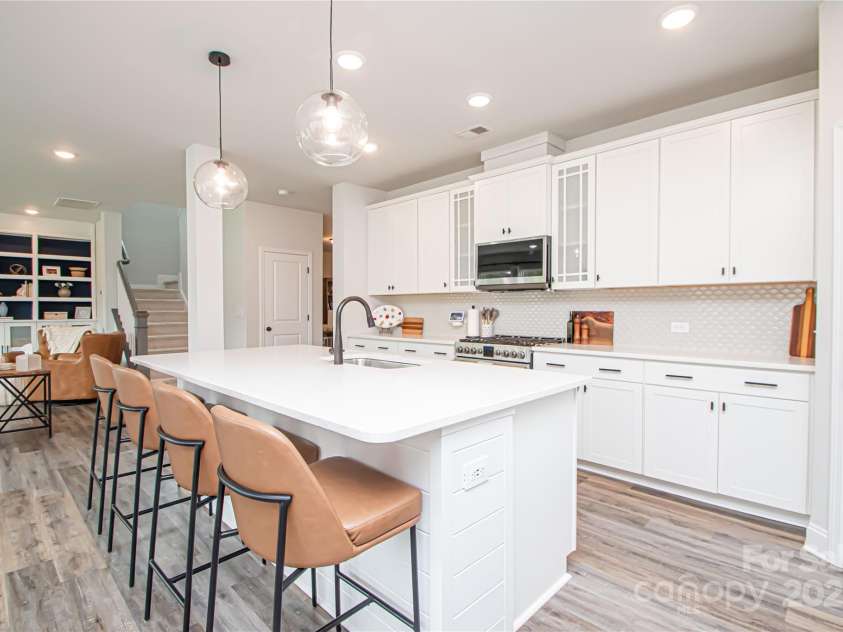 1061 Ansley Park Drive, Fort Mill, SC 29707.  MLS# CAR4281028, YatesRealty ID 32626. The open floor plan seamlessly connects the kitchen, dining area, and family room—ideal for everyday living and entertaining.