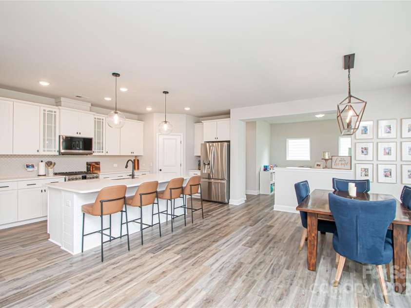 1061 Ansley Park Drive, Fort Mill, SC 29707.  MLS# CAR4281028, YatesRealty ID 32626. The open floor plan seamlessly connects the kitchen, dining area, and family room—ideal for everyday living and entertaining.