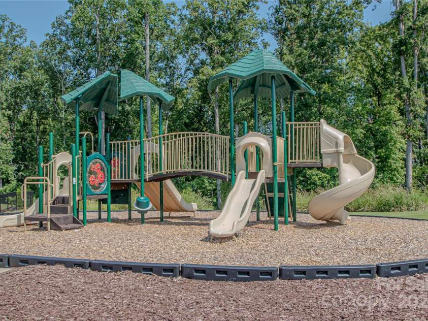 1061 Ansley Park Drive, Fort Mill, SC 29707.  MLS# CAR4281028, YatesRealty ID 32626. The park, located adjacent to the pool, offers a variety of slides and activities—making it a fantastic spot for kids to play and explore.