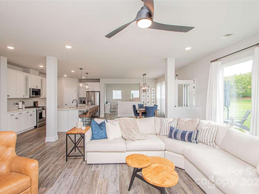 1061 Ansley Park Drive, Fort Mill, SC 29707.  MLS# CAR4281028, YatesRealty ID 32626. The spacious family room flows seamlessly into the kitchen and dining area, creating an open and inviting living space.