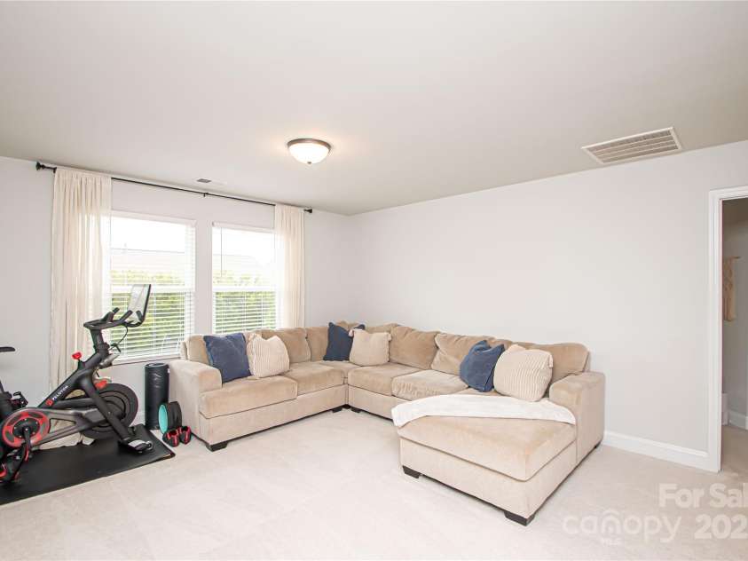 1061 Ansley Park Drive, Fort Mill, SC 29707.  MLS# CAR4281028, YatesRealty ID 32626. The spacious loft serves as a second family room and offers flexibility to be used as a playroom, home office, or workout space—whatever suits your needs.