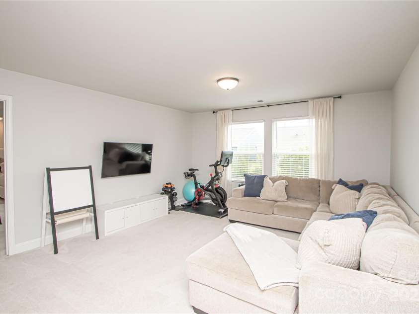 1061 Ansley Park Drive, Fort Mill, SC 29707.  MLS# CAR4281028, YatesRealty ID 32626. The spacious loft serves as a second family room and offers flexibility to be used as a playroom, home office, or workout space—whatever suits your needs.