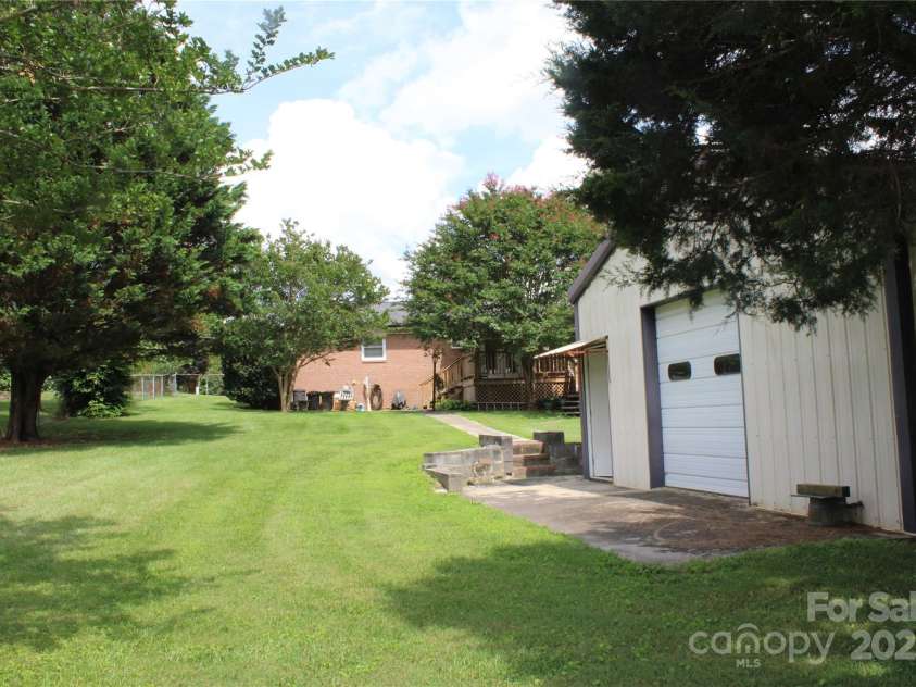 116 Woodbark Lane, Kings Mountain, NC 28086.  MLS# CAR4268258, YatesRealty ID 32630. View from lower backyard of shop and house