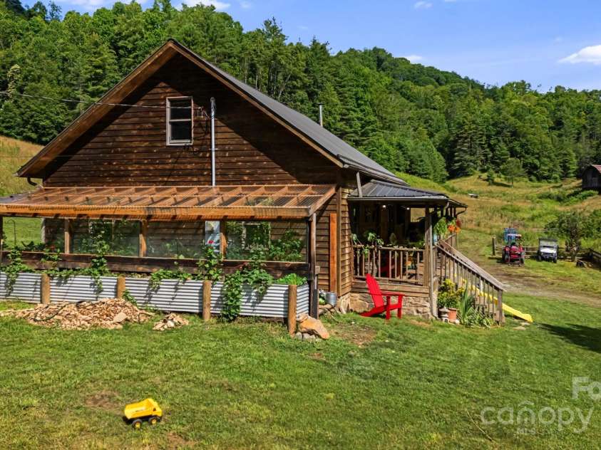 799 Fire Scald Road, Green Mountain, NC 28740.  MLS# CAR4226688, YatesRealty ID 32632. Greenhouse on side of home