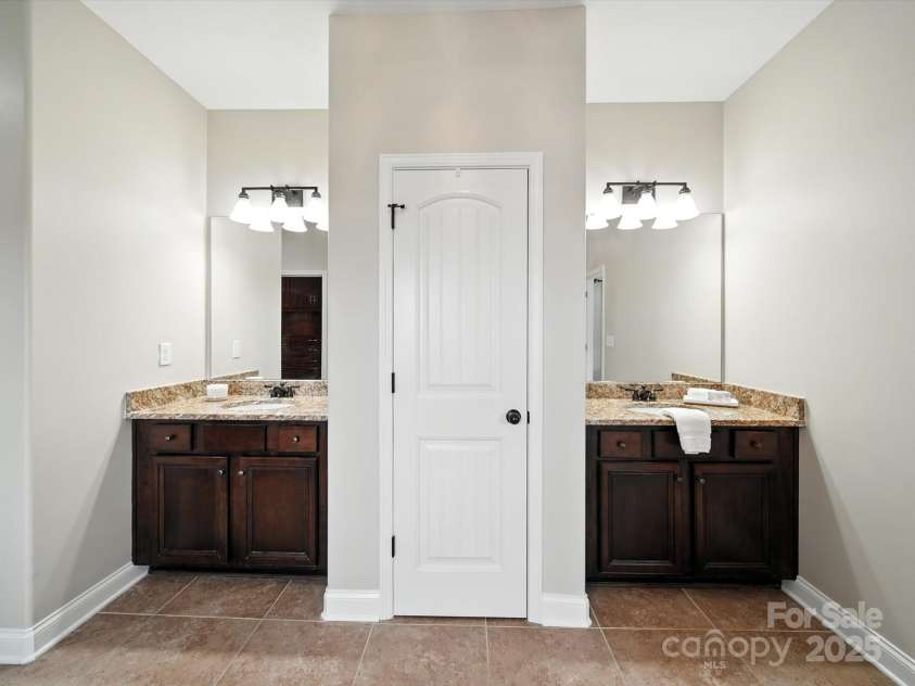 1402 Wynhurst Drive, Waxhaw, NC 28173.  MLS# CAR4290603, YatesRealty ID 32635. Dual sinks and linen closet.