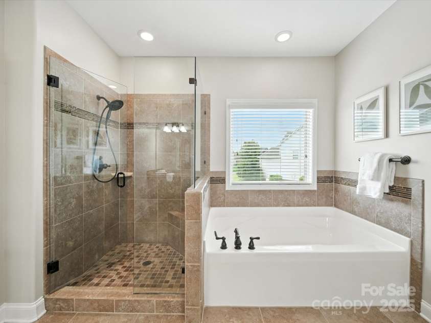 1402 Wynhurst Drive, Waxhaw, NC 28173.  MLS# CAR4290603, YatesRealty ID 32635. Spa-like walk in shower and garden tub for relaxation.