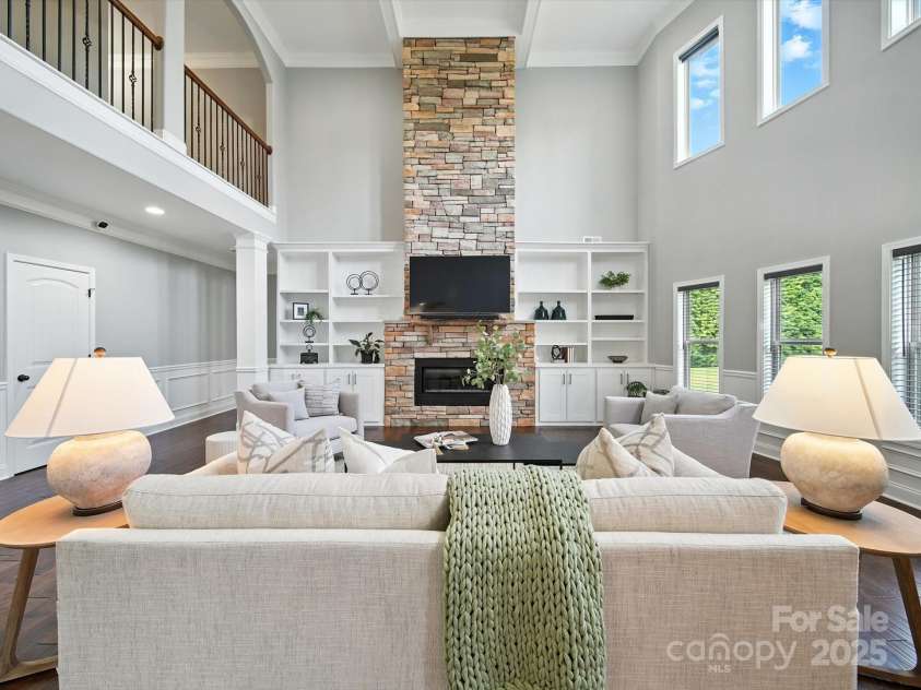 1402 Wynhurst Drive, Waxhaw, NC 28173.  MLS# CAR4290603, YatesRealty ID 32635. Stacked stone 2-story fireplace flanked by built-in bookcases.