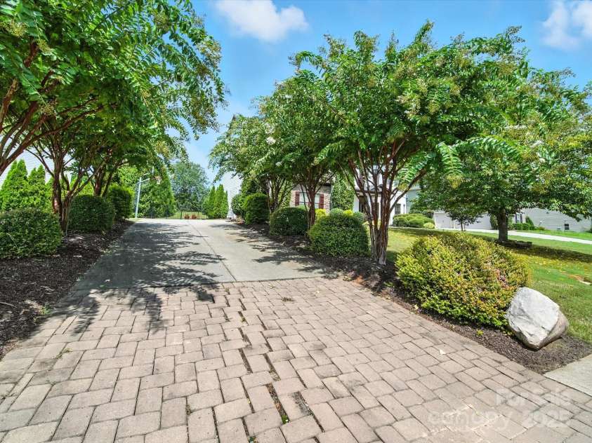 1402 Wynhurst Drive, Waxhaw, NC 28173.  MLS# CAR4290603, YatesRealty ID 32635. Tree-lined driveway complemented by brick pavers.