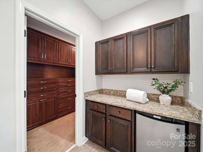 1402 Wynhurst Drive, Waxhaw, NC 28173.  MLS# CAR4290603, YatesRealty ID 32635. Unique built-in area w/countertop, mini fridge and cabinets - ideal for a coffee bar. This pic also shows the left side of the enormous closet with custom built-ins.