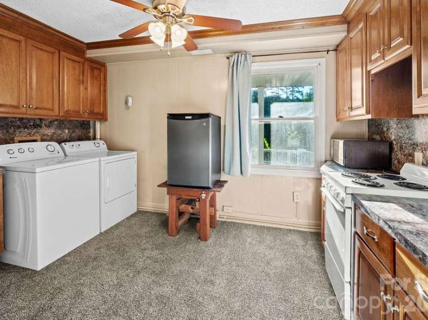47209 Paradise Lane, Norwood, NC 28128.  MLS# CAR4385210, YatesRealty ID 32637. Laundry and kitchen in guest quarters