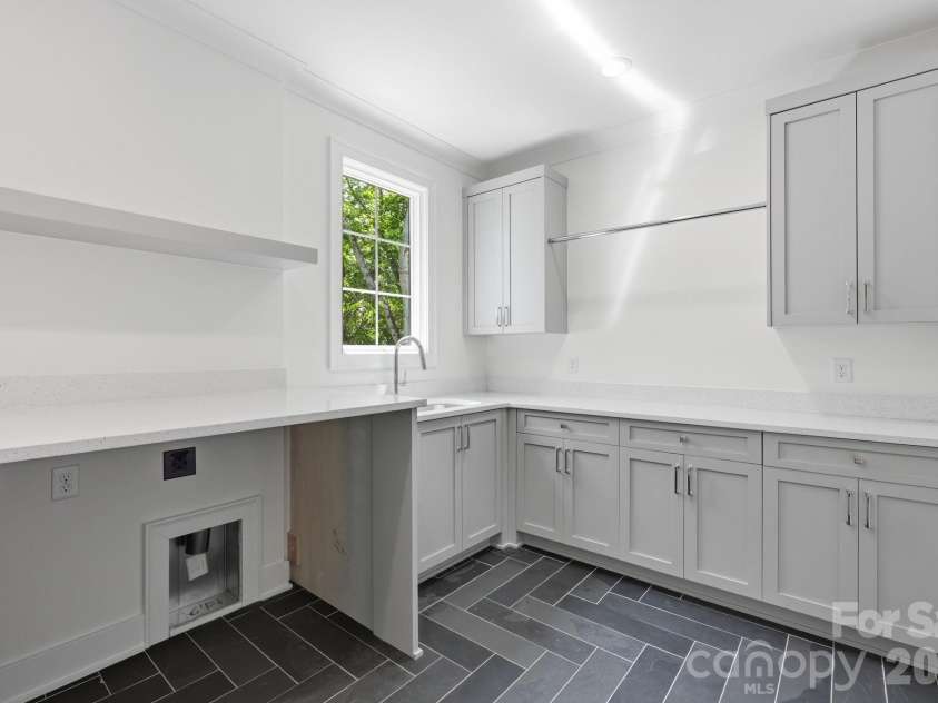 235 Jetton Street, Davidson, NC 28036.  MLS# CAR4391336, YatesRealty ID 32675. Large laundry room located on second level