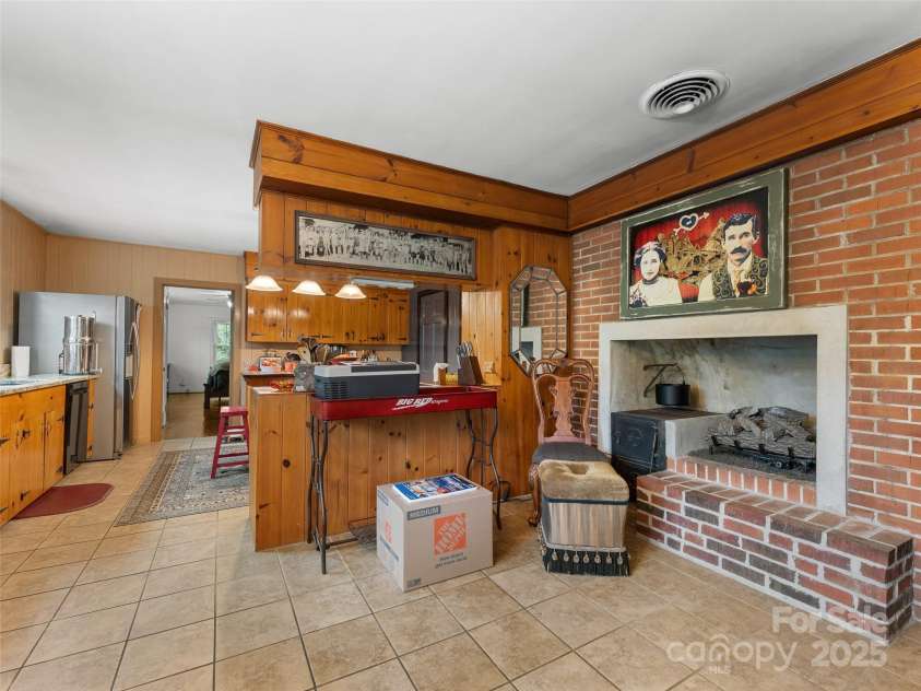 437 Rutledge Drive, Hendersonville, NC 28739.  MLS# CAR4286995, YatesRealty ID 32686. Dining area with fireplace