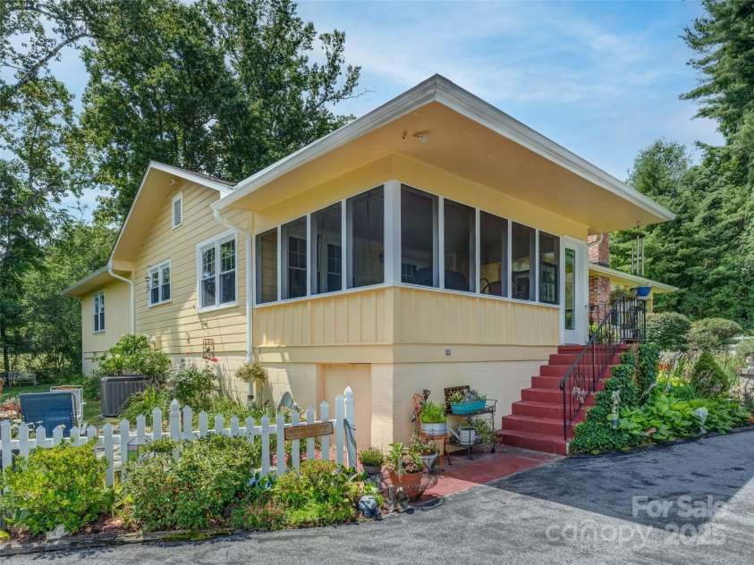 437 Rutledge Drive, Hendersonville, NC 28739.  MLS# CAR4286995, YatesRealty ID 32686. Exterior view of the screened in porch.  Excellent area to sit and relax in the mornings or evenings.