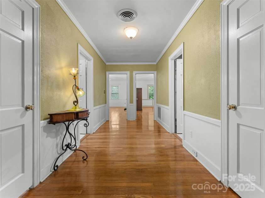 437 Rutledge Drive, Hendersonville, NC 28739.  MLS# CAR4286995, YatesRealty ID 32686. Hallway with bathrooms on each side and bedrooms at the end.