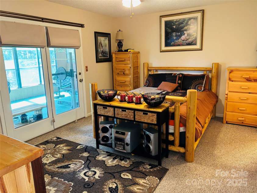 8799 Lisa Trail, Connelly Springs, NC 28612.  MLS# CAR4292879, YatesRealty ID 32719. Large Primary Bedroom with Doors Leading to Sunroom
