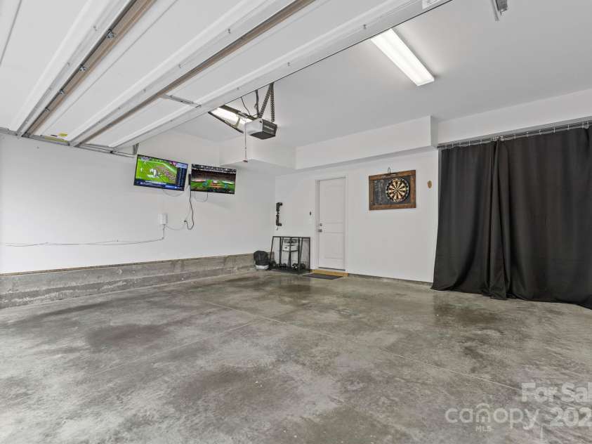 9324 Ainslie Downs Street, Charlotte, NC 28273.  MLS# CAR4276597, YatesRealty ID 32727. 2-car garage already complete with 2 mounted TVs and dartboard for your football Sundays this fall! (plus extra storage space)