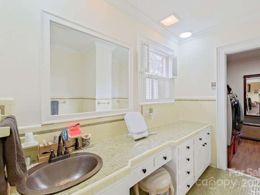 206 Trexler Avenue, Rockwell, NC 28138.  MLS# CAR4198633, YatesRealty ID 3273. Primary bath one has a washer and dryer in the walk in closet, a tub, and a large vanity area.