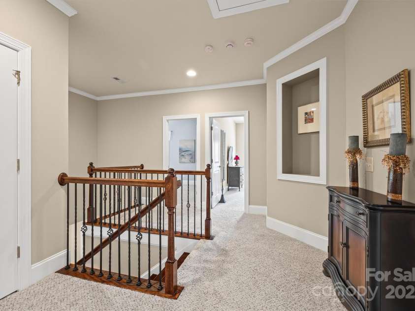 703 English Tudor Lane, Charlotte, NC 28211.  MLS# CAR4259545, YatesRealty ID 32734. Landing at the top of the stairs with wall inset for art display.