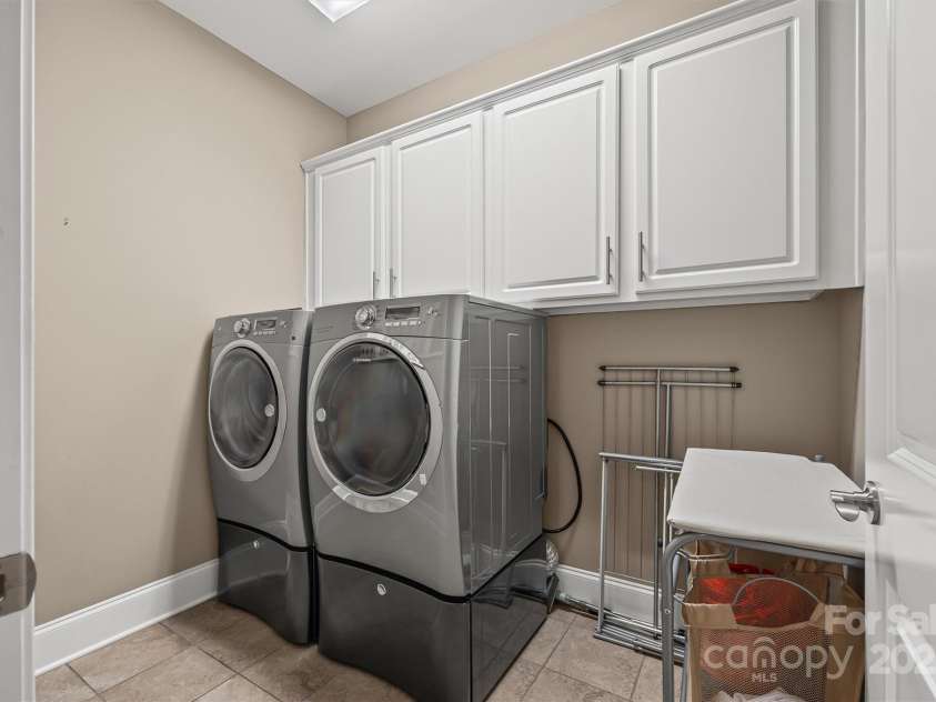 703 English Tudor Lane, Charlotte, NC 28211.  MLS# CAR4259545, YatesRealty ID 32734. Laundry room with built-in cabinetry