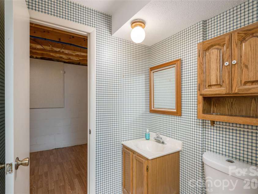 615 Goldview Drive, Hendersonville, NC 28791.  MLS# CAR4396945, YatesRealty ID 32735. Lower level half bath