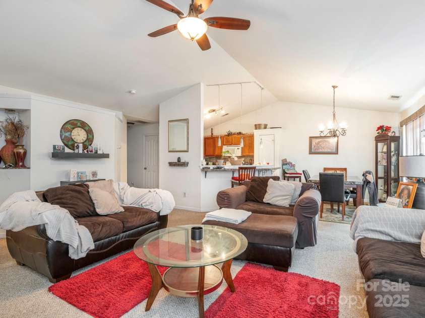 7941 Mossycup Drive, Charlotte, NC 28215.  MLS# CAR4292875, YatesRealty ID 32751. Living Room into Dining & Kitchen