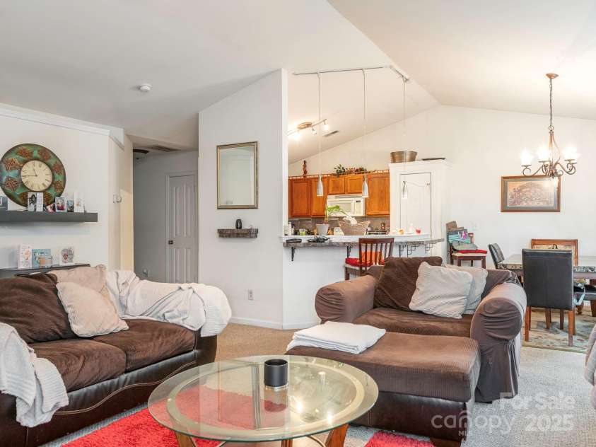 7941 Mossycup Drive, Charlotte, NC 28215.  MLS# CAR4292875, YatesRealty ID 32751. Living Room into Dining & Kitchen