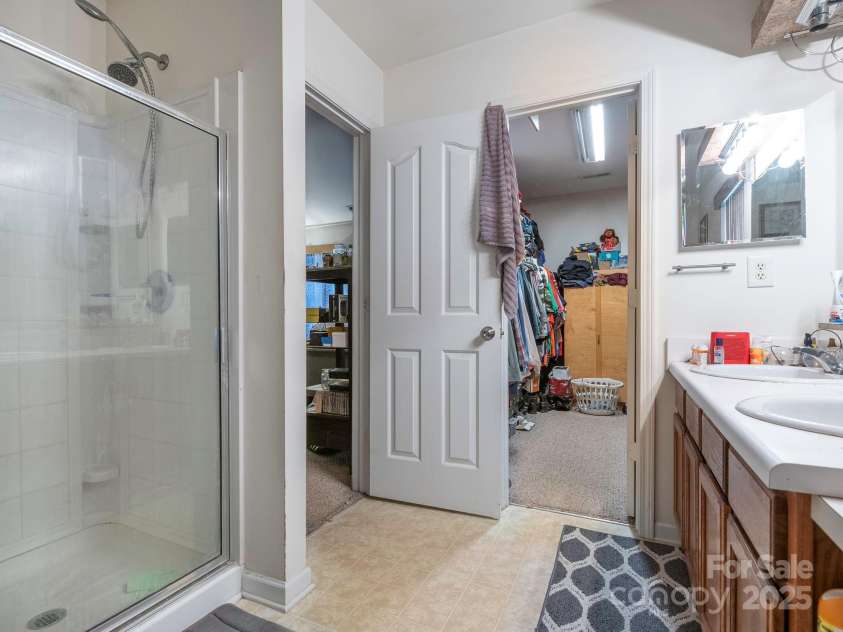 7941 Mossycup Drive, Charlotte, NC 28215.  MLS# CAR4292875, YatesRealty ID 32751. Primary Bathroom into walk-in closet