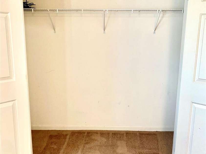 6025 Creft Circle, Indian Trail, NC 28079.  MLS# CAR4387929, YatesRealty ID 32758. Secondary Bedroom spacious closet with shelves on the right.
