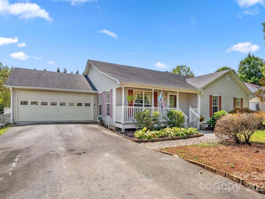 27 Eden Glen Road, Black Mountain, NC 28711.  MLS# CAR4292054, YatesRealty ID 3277. A picture-perfect front view—covered porch, mature landscaping, and level driveway.