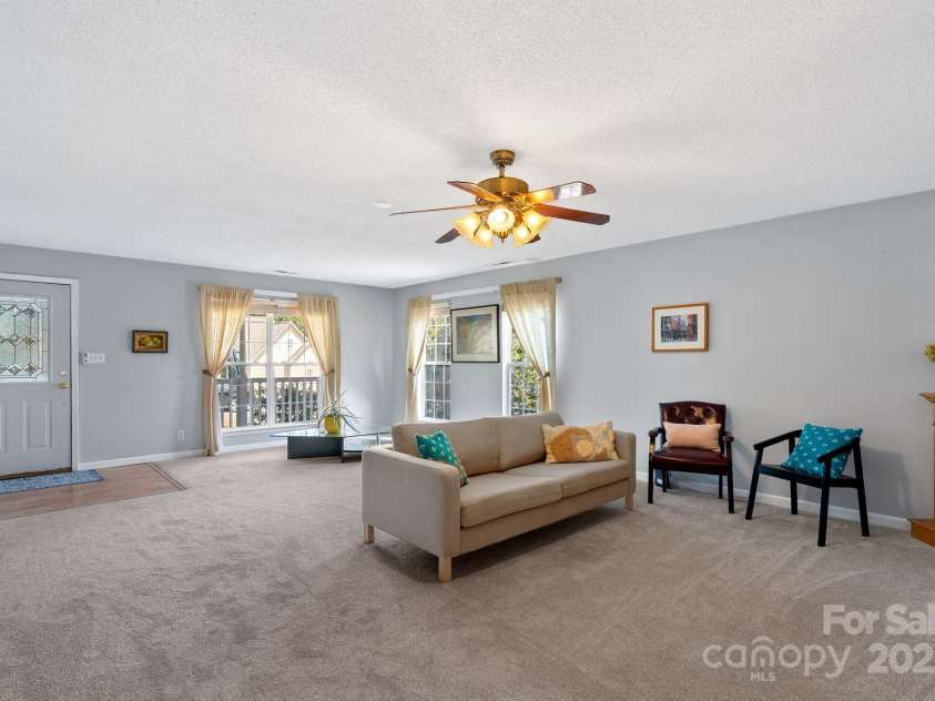 27 Eden Glen Road, Black Mountain, NC 28711.  MLS# CAR4292054, YatesRealty ID 3277. Fresh carpet, neutral colors, and sun-filled windows make this living room the perfect blend of comfort and versatility.