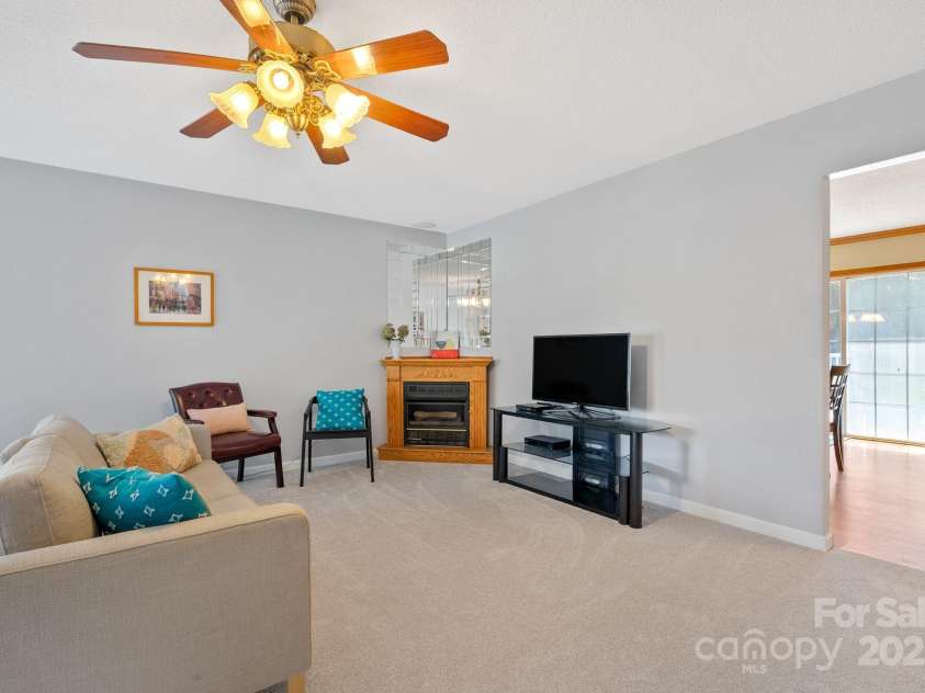 27 Eden Glen Road, Black Mountain, NC 28711.  MLS# CAR4292054, YatesRealty ID 3277. Gather around the gas fireplace in this inviting living area, perfect for quiet evenings.