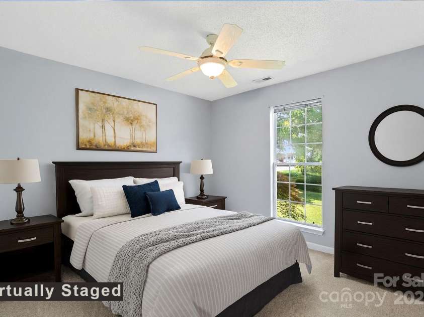 27 Eden Glen Road, Black Mountain, NC 28711.  MLS# CAR4292054, YatesRealty ID 3277. Inviting bedroom with a ceiling fan, neutral palette, and plenty of natural light.