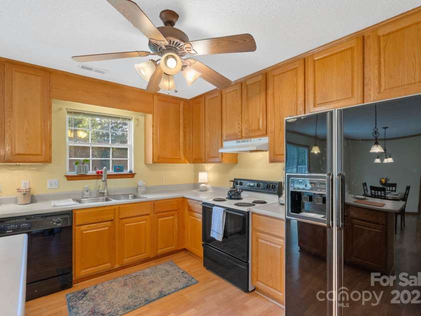 27 Eden Glen Road, Black Mountain, NC 28711.  MLS# CAR4292054, YatesRealty ID 3277. This kitchen blends convenience, storage, and light for a warm, functional space.